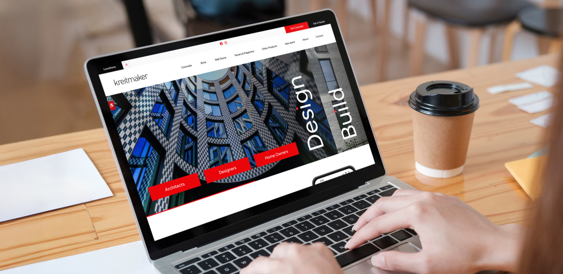 A laptop screen shows the kreitmaker website, which is hosted on Tymbrel.