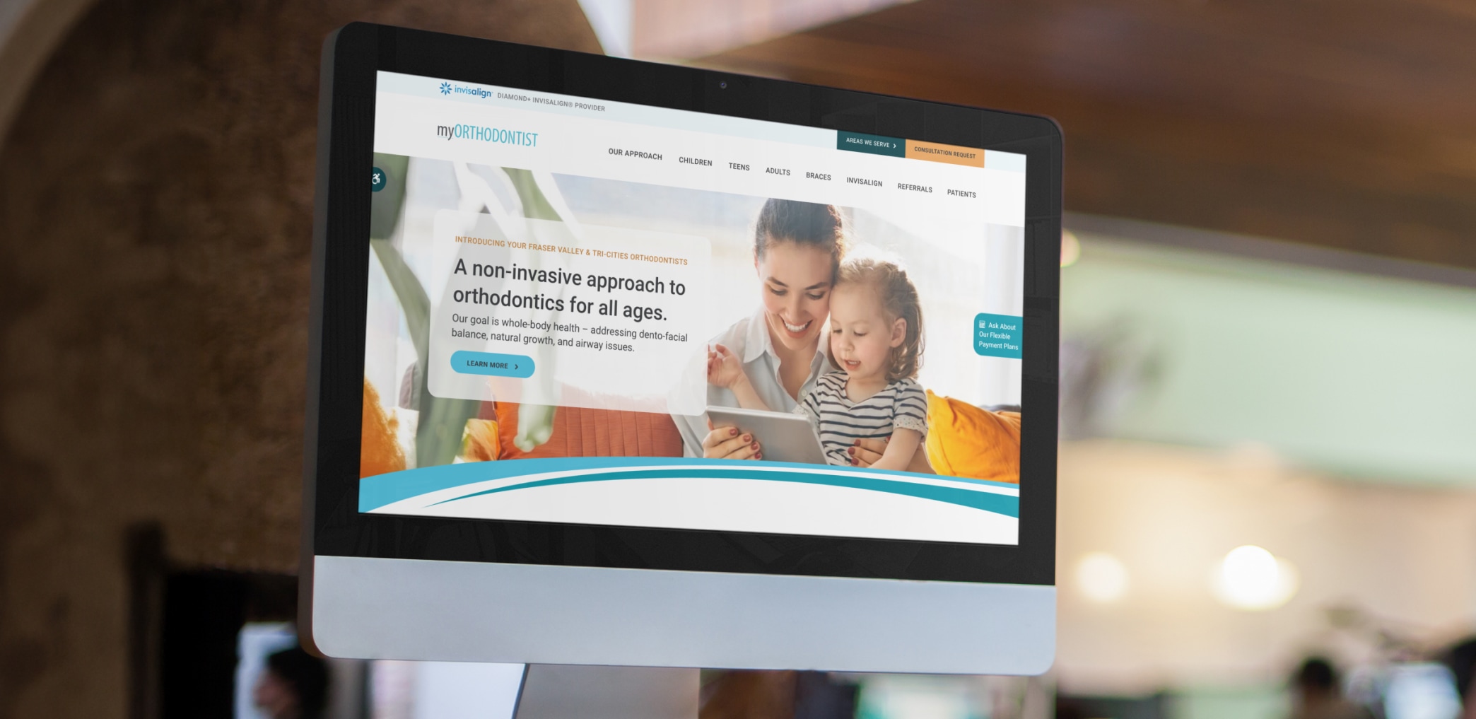 A laptop screen shows the myORTHODONTIST website, which is hosted on Tymbrel.