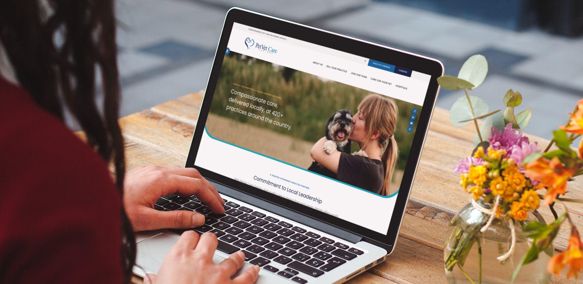 A laptop screen shows the PetVet Care Centers website, which is hosted on Tymbrel.