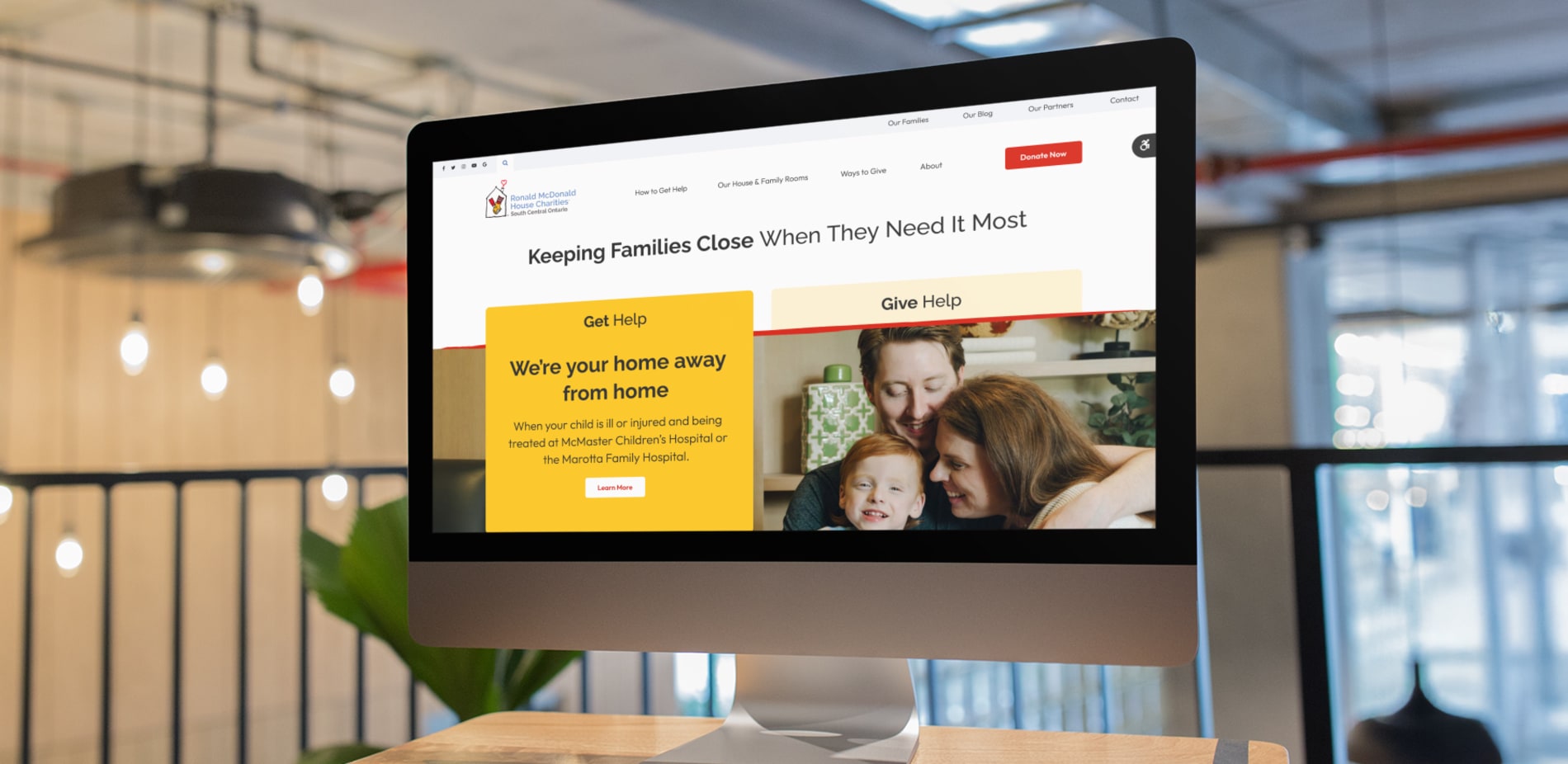 A computer screen shows the Ronald McDonald House Charities website, which is hosted on Tymbrel.