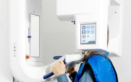 Patient at Duong Orthodontics in a CBCT machine getting scanned.